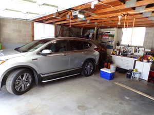 Garage featuring a workshop area and a garage door opener