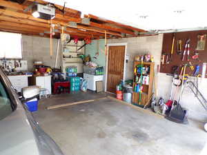 Garage with a workshop area and a garage door opener