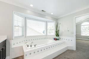 Full bathroom with a bath, ornamental molding, vanity, and recessed lighting