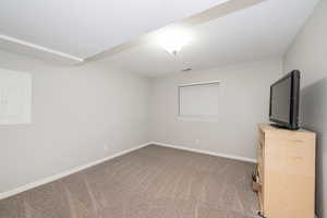 Unfurnished bedroom featuring electric panel, light carpet, and a textured ceiling