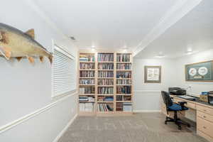 Office area featuring light carpet, a textured ceiling, and crown molding