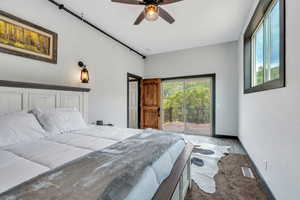 Bedroom with access to exterior, a ceiling fan, carpet flooring, and wood finished floors
