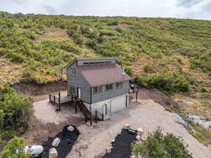 View from above of property featuring a heavily wooded area