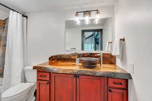 Full bath featuring vanity and shower / bath combination with curtain