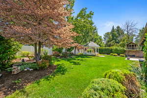 Fenced backyard featuring a gazebo
