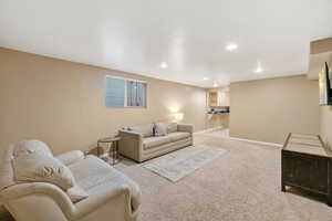 Living area featuring carpet floors and recessed lighting