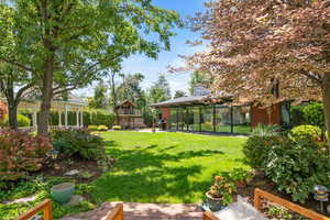 View of yard with a patio and a sunroom