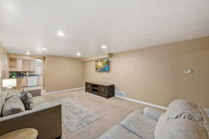 Living room with light carpet and recessed lighting