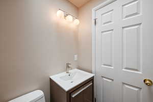 Half bath with vanity and toilet