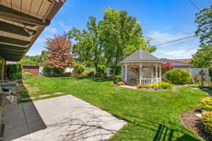 Fenced backyard with a gazebo and a patio