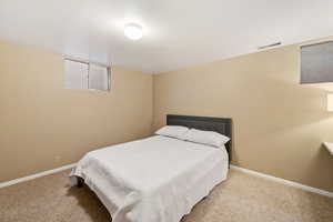 Carpeted bedroom featuring baseboards
