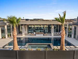 View of pool featuring a patio and a pool with connected hot tub