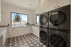 Laundry room featuring cabinet space and light floors