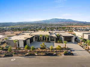 View of front of house with a mountain view and driveway