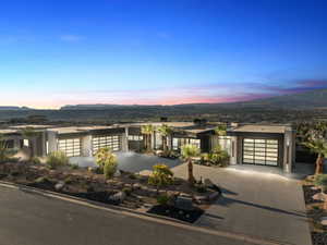 View of front facade featuring concrete driveway, an attached garage, stucco siding, and a mountain view