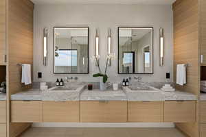 Bathroom featuring double vanity and light tile patterned floors