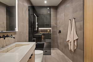 Full bathroom with a walk in shower, tile walls, and vanity