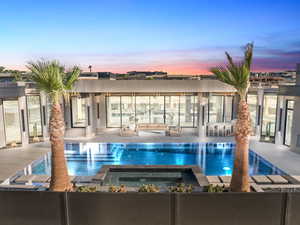 View of pool featuring a patio area and a pool with connected hot tub