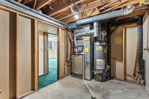 Utility room featuring gas water heater and heating unit
