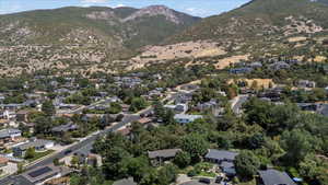 View of property location with a mountain backdrop and nearby suburban area