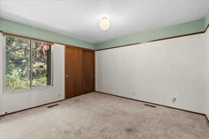 Unfurnished bedroom featuring a closet and carpet