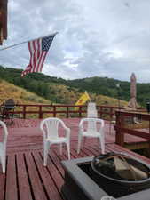 Wooden terrace featuring a grill and a mountain view