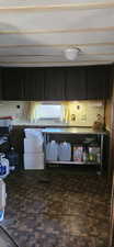 Kitchen featuring dark cabinets
