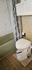 Full bath featuring toilet and shower / bath combination
