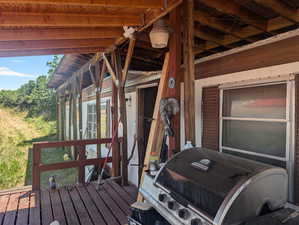 Wooden deck featuring area for grilling