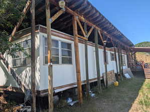 View of property exterior with a wooden deck