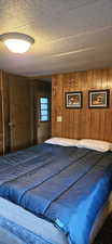 Bedroom featuring wood walls