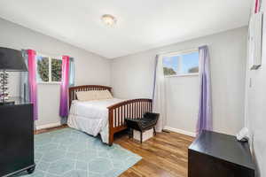 Bedroom featuring light wood-style flooring and baseboards