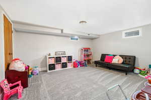 Recreation room with carpet and baseboards