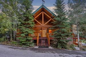 north east side of house. Front door entrance. Log cabin with stairs and log exterior