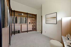 Bedroom featuring light carpet and baseboards