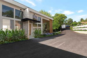 Entrance to property featuring stone siding