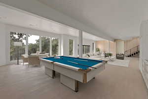 Recreation room with billiards and light wood-style floors
