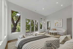 Bedroom featuring access to exterior, recessed lighting, high vaulted ceiling, and wood finished floors