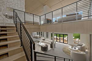 Living room featuring a towering ceiling and stairs