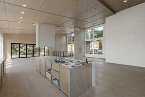 Kitchen featuring recessed lighting, light brown cabinetry, modern cabinets, light wood-style floors, and open floor plan