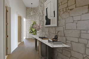 Corridor with wood finished floors and an office area