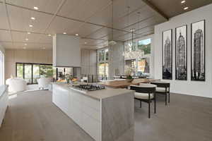 Kitchen featuring modern cabinets, recessed lighting, decorative light fixtures, white cabinets, and light wood-style flooring