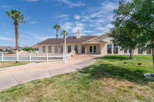 Ranch-style house featuring stucco siding and a chimney
