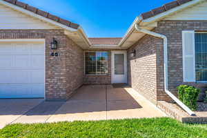 Property entrance with a garage and brick siding