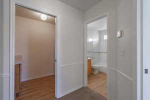 Hall with light wood-type flooring and baseboards