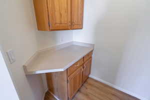Kitchen featuring light countertops, brown cabinets, and light wood-type flooring