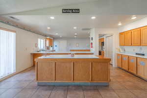 Kitchen with light countertops, recessed lighting, light tile patterned floors, and a textured ceiling