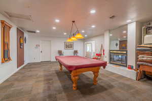 Recreation room featuring carpet floors, recessed lighting, billiards, and a tiled fireplace