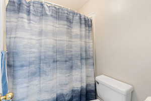 Bathroom with a shower with shower curtain