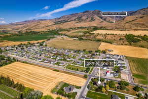 View of property location with nearby suburban area, mountains, and property parcel outlined
